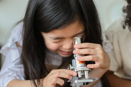 Child peers into microscope